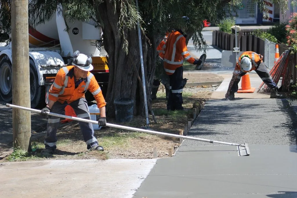 Home 3 Crew working on fresh concrete sidewalk.