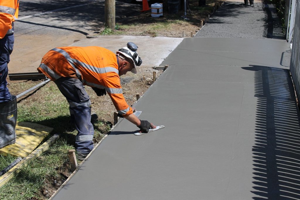 Repaired concrete sidewalk with clean, even sections.